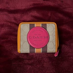 This is a small coach wallet fit for a princess